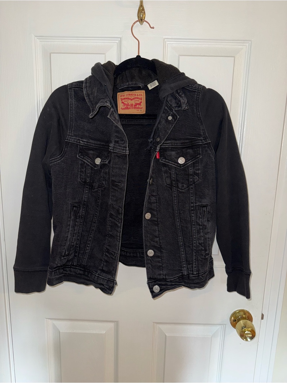 Black Levi’s denim trucker jacket with attached fleece hoodie sleeves